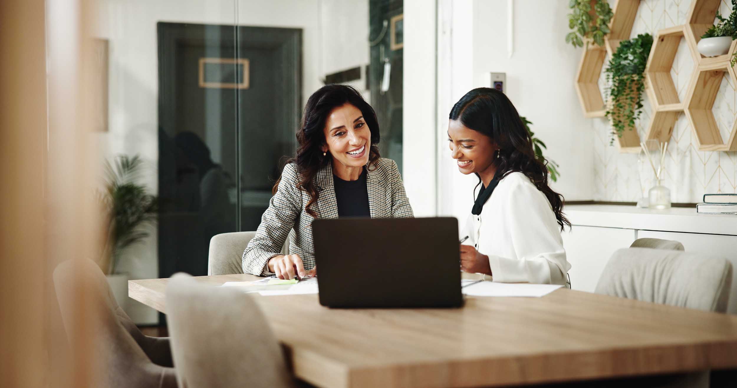 Meeting, women and business people with laptop in office